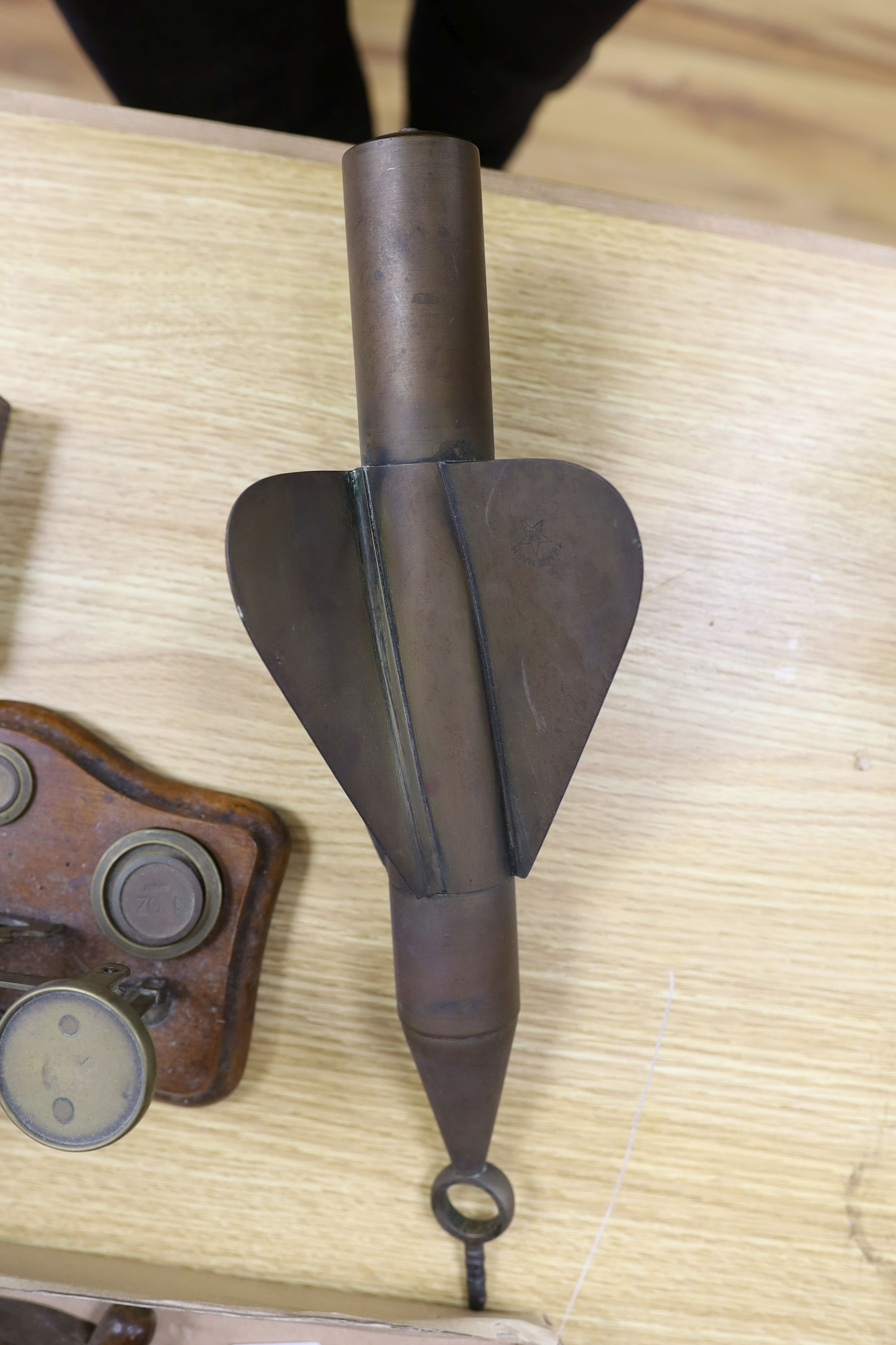 A box of curios including ship's log, brass projectile arrow and postal scales